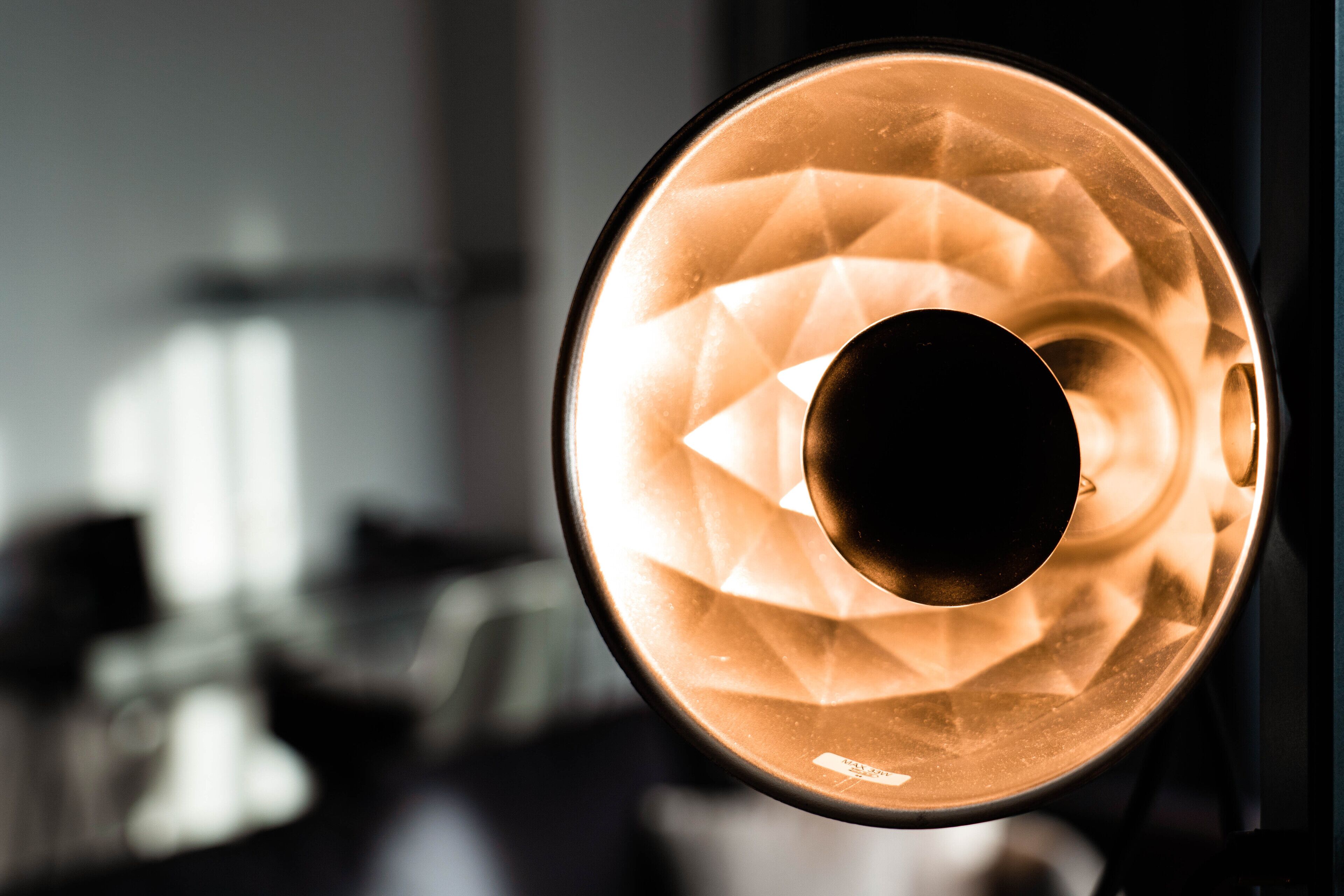 A close-up of a circular, textured light fixture with a central dark circle.