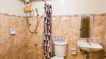 A bathroom with a shower, toilet, sink, and a sign prohibiting trash in the toilet.