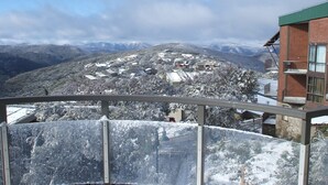 A snow-covered mountain village with buildings and a clear sky.