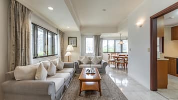 Deluxe Suite, 2 Bedrooms, Kitchen, City View | Living area | 43-inch flat-screen TV with cable channels, TV, DVD player