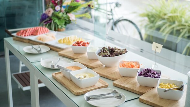 A buffet table with various dishes and condiments. - Veethara Boutique Hotel (Udon Thani)