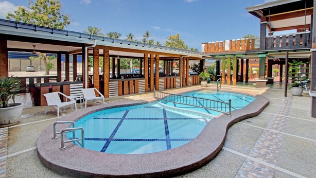 A swimming pool with lounge chairs and a covered seating area. - MyVilla Langkawi Hotel (Langkawi)