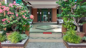 A hotel entrance with a tiled floor, a red mat, and potted plants. - MyVilla Langkawi Hotel (Langkawi)