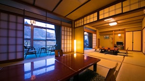 A traditional Japanese room with tatami flooring, a low table, and sliding doors. - Seishounagon (Tsu)