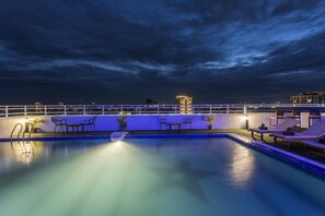 Outdoor pool, a rooftop pool, pool umbrellas, sun loungers