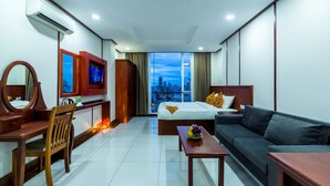 A hotel room with a bed, a sofa, a desk, and a TV. - Le Mont Hotel (Phnom Penh)