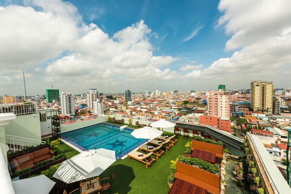 Outdoor pool, a rooftop pool, pool umbrellas, sun loungers