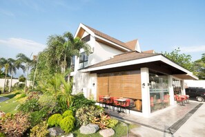 Una casa moderna con un patio que incluye mobiliario exterior.