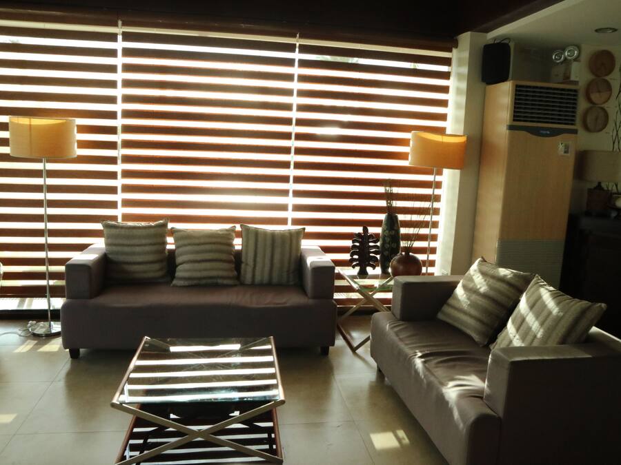 A living room with a sofa, a coffee table, and a lamp.