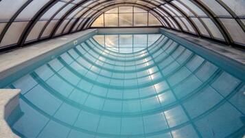 Indoor pool, outdoor pool, pool umbrellas, pool loungers