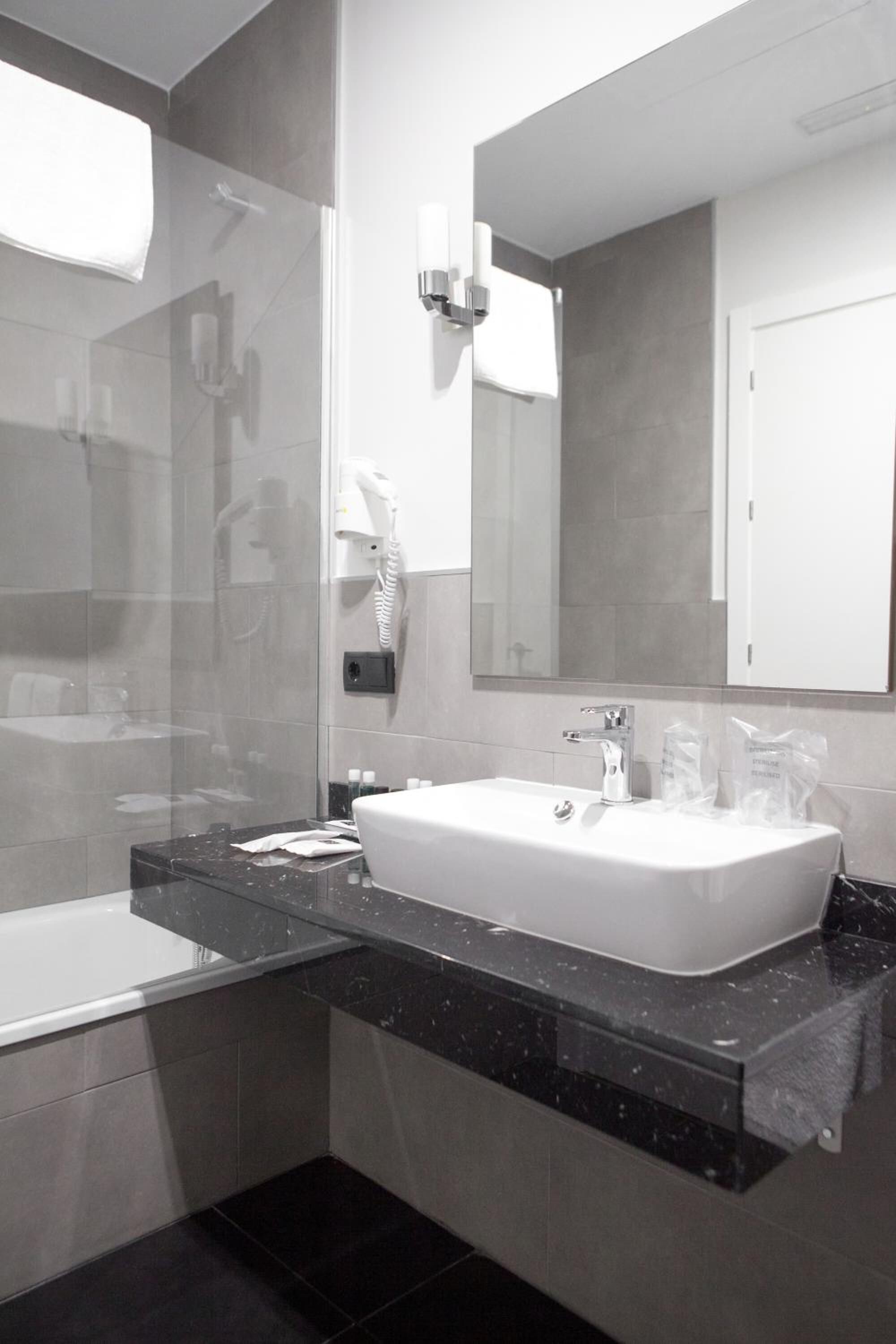 designer toiletries, hair dryer, towels