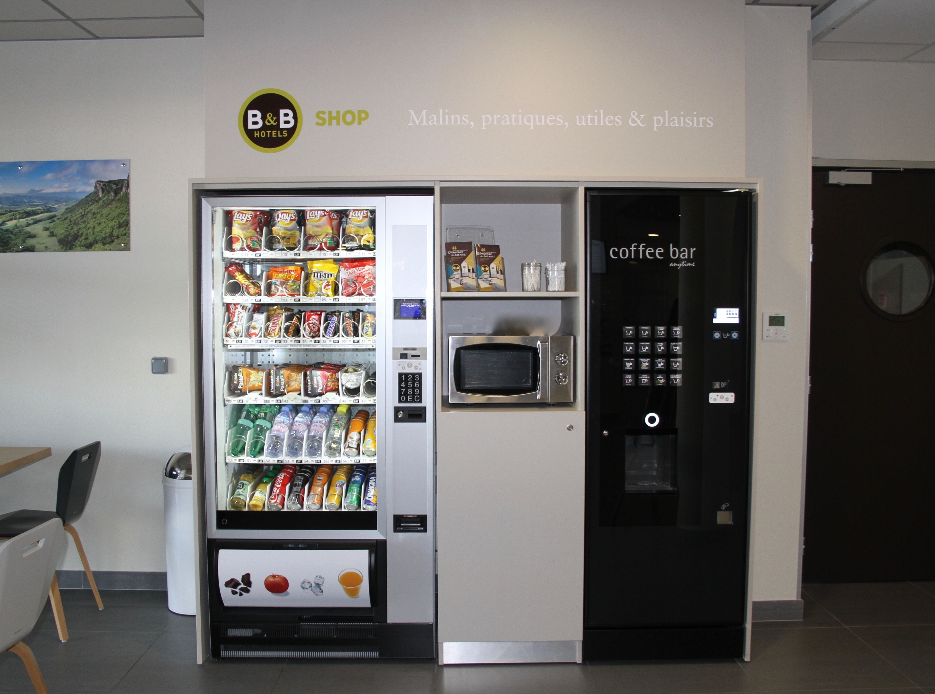 A B&B shop with a vending machine stocked with snacks and drinks, a microwave, and a coffee bar.