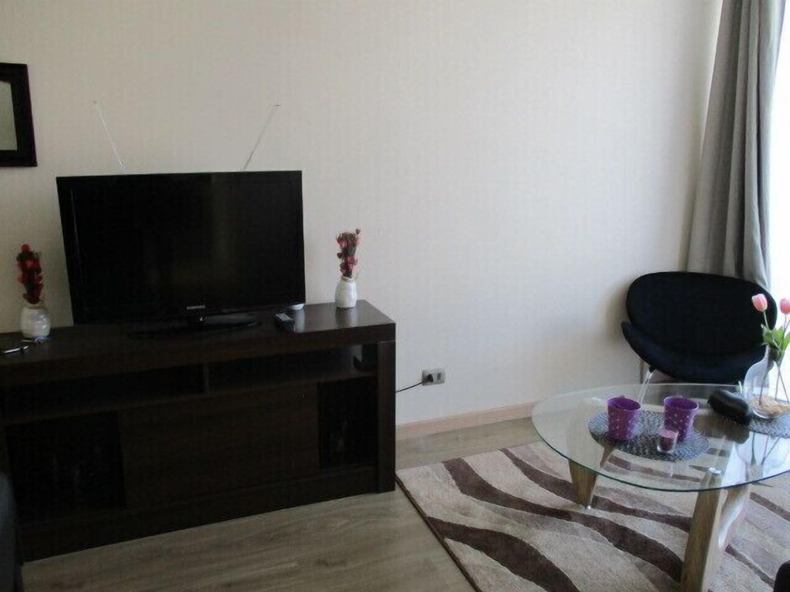 Family Apartment, 3 Bedrooms, Balcony, Pool View | Living area | 50-inch flat-screen TV with cable channels, TV