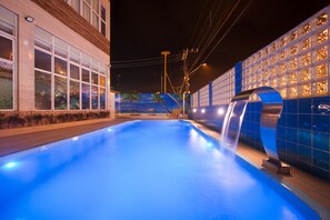 Relax by the pool surrounded by a geometric patterned wall and soothing water feature.