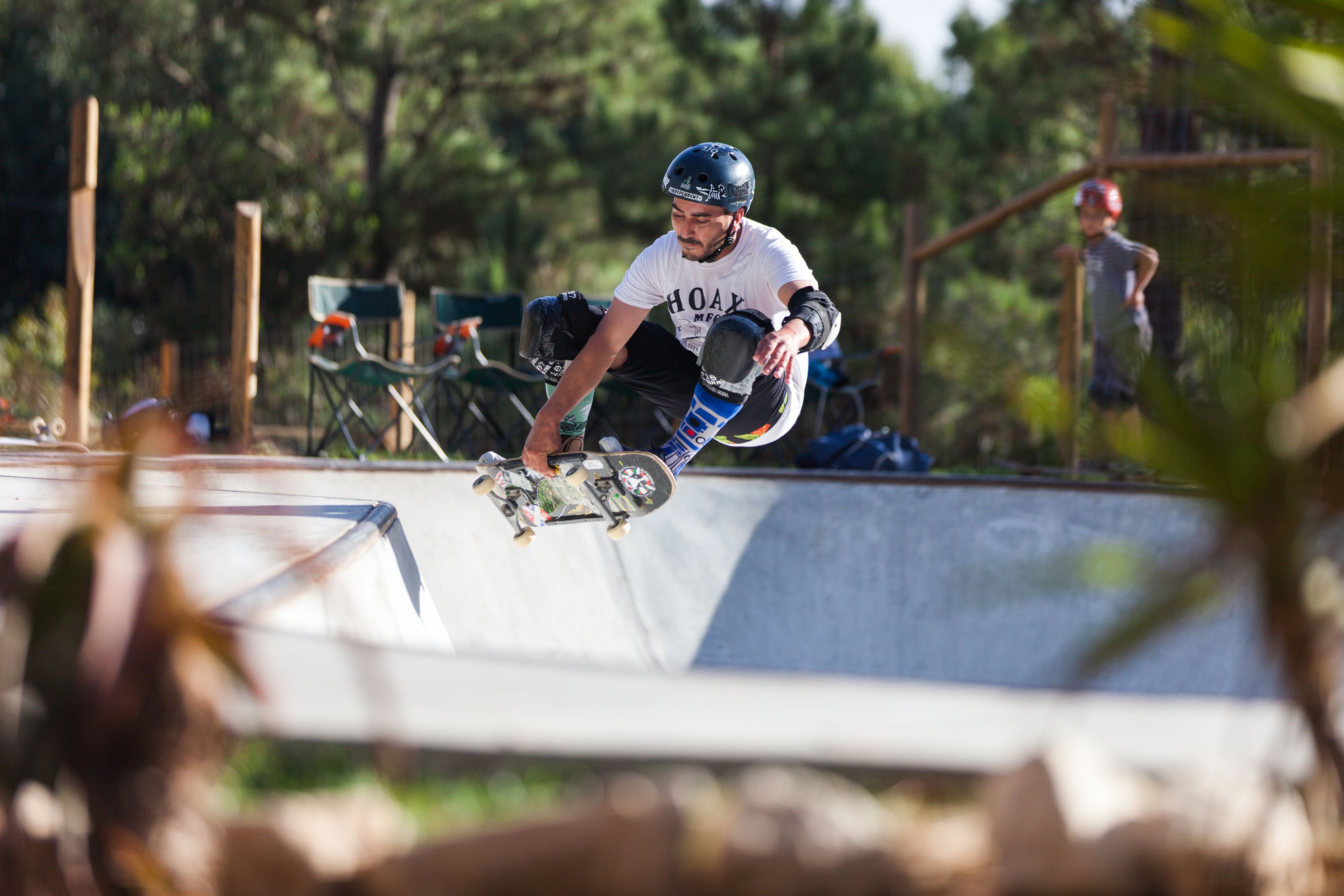 A skateboarder performing a trick at a skatepark.