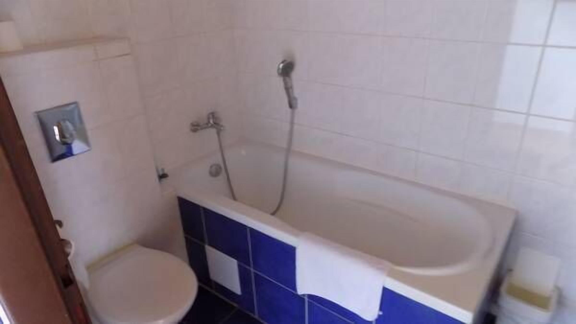 Ein Badezimmer mit Badewanne, Toilette und Dusche.