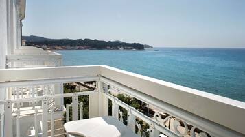 A balcony with a view of the sea and a distant coastline.
