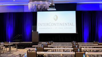 A conference room with a large screen displaying 'INTERCONTINENTAL MINNEAPOLIS - ST. PAUL AIRPORT'.