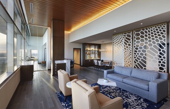 A modern hotel lobby with a seating area, a dining space, and a kitchen visible through glass walls. - InterContinental Minneapolis - St. Paul Airport by IHG (Minneapolis)