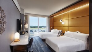A hotel room with two beds, a desk, a chair, and a large window offering a view of the airport. - InterContinental Minneapolis - St. Paul Airport by IHG (Minneapolis)