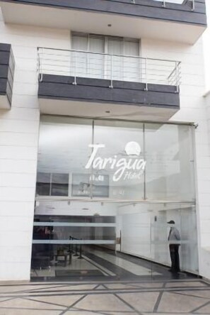 Experience the sleek, modern design of Tarigua Hotel's exterior, featuring a glass facade and inviting balcony.