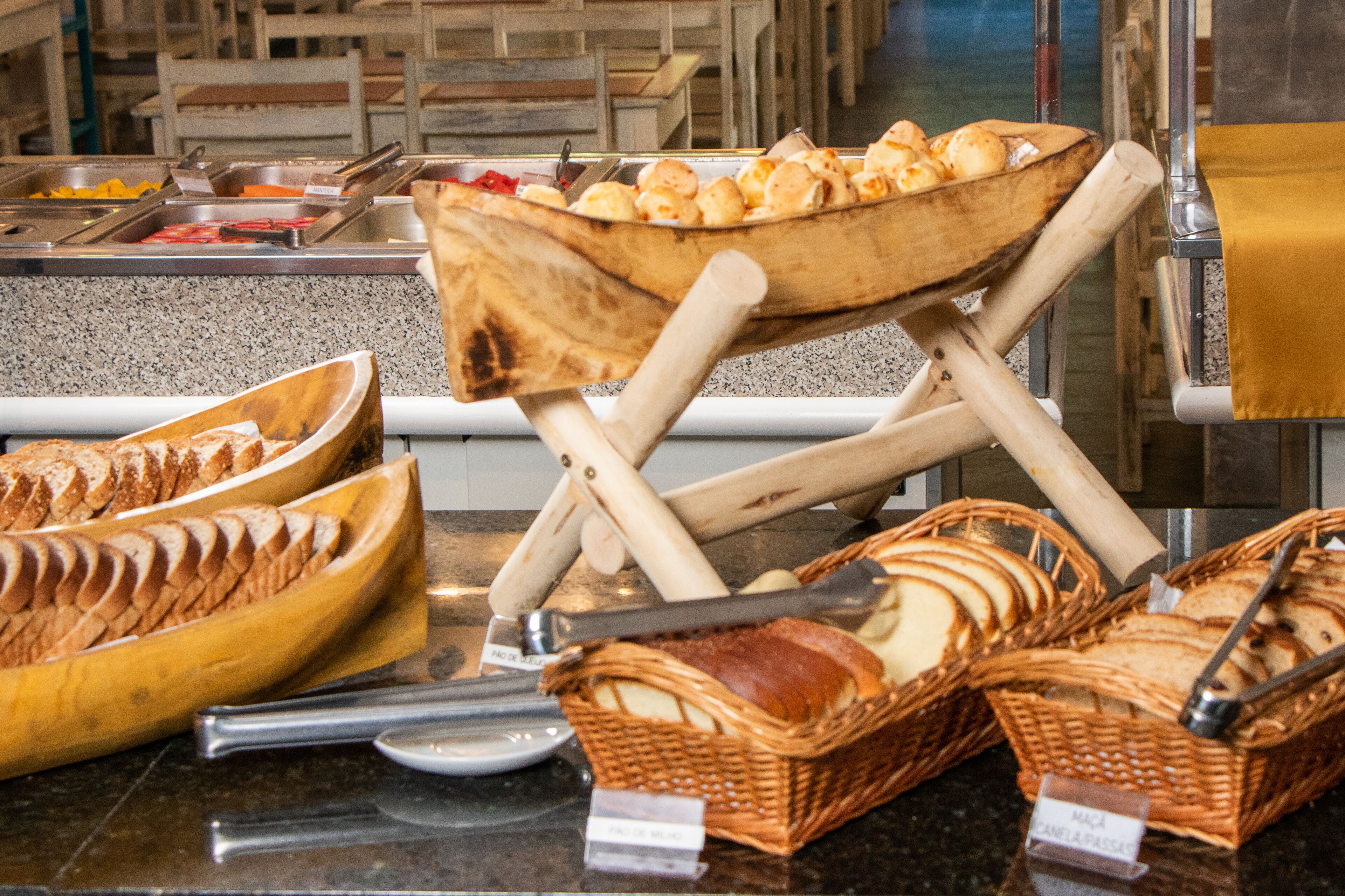 A buffet setup with various food items and serving utensils.
