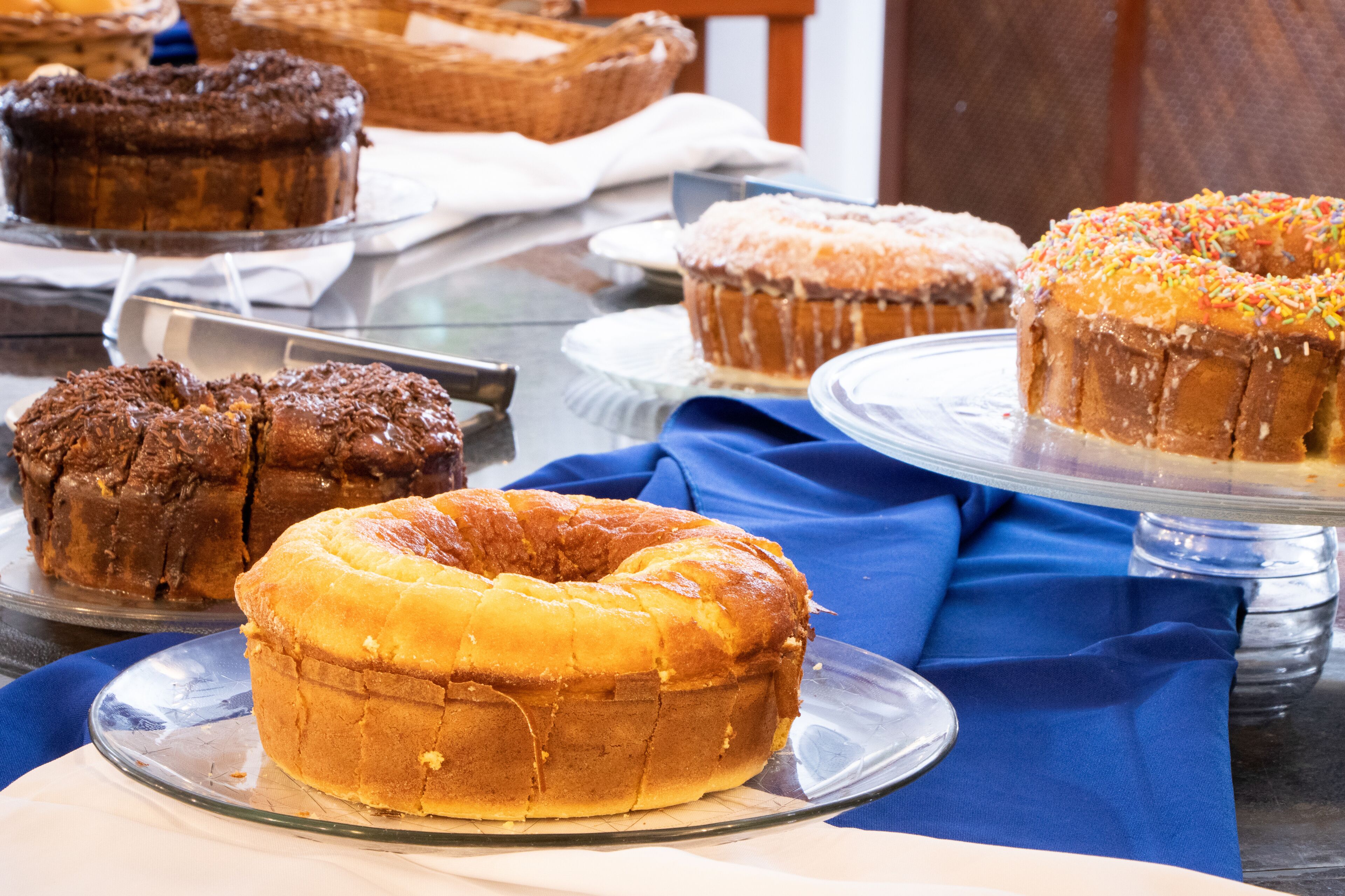A variety of baked goods displayed on clear glass plates.