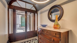 A wooden dresser with drawers, a vase, and a bowl on top.