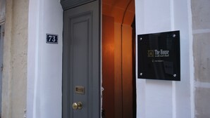 A door with a number plate '73' and a sign for 'The House in old mint street'.