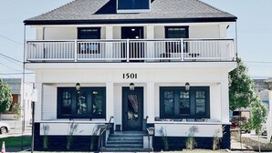 A two-story building with a balcony on the upper floor, a front entrance with steps, and the number 1501 displayed above the entrance. - The Landing Hotel and Dining (La Grande)