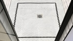 A tiled ceiling with a geometric pattern and a decorative wall with a symmetrical design. - The Landing Hotel and Dining (La Grande)
