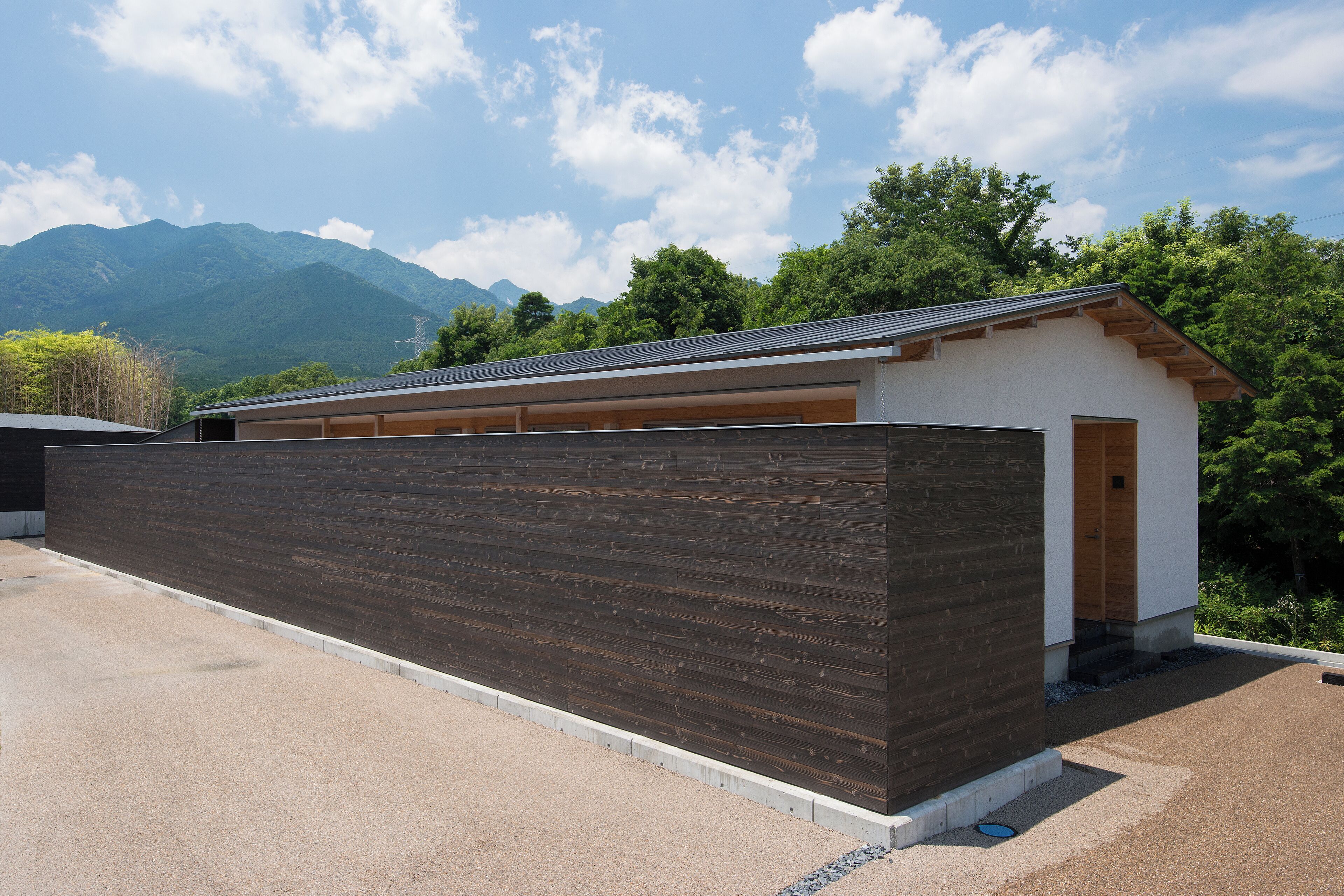 A modern building with a wooden exterior and a garage.