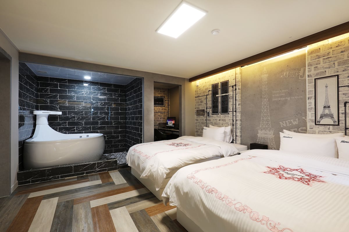 A modern bathroom with a freestanding bathtub, a shower area, and a vanity.