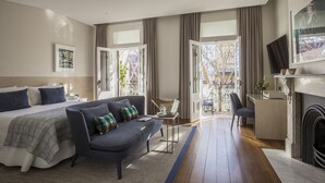 A modern hotel room with a bed, sofa, desk, and fireplace. - Spicers Potts Point (Potts Point)