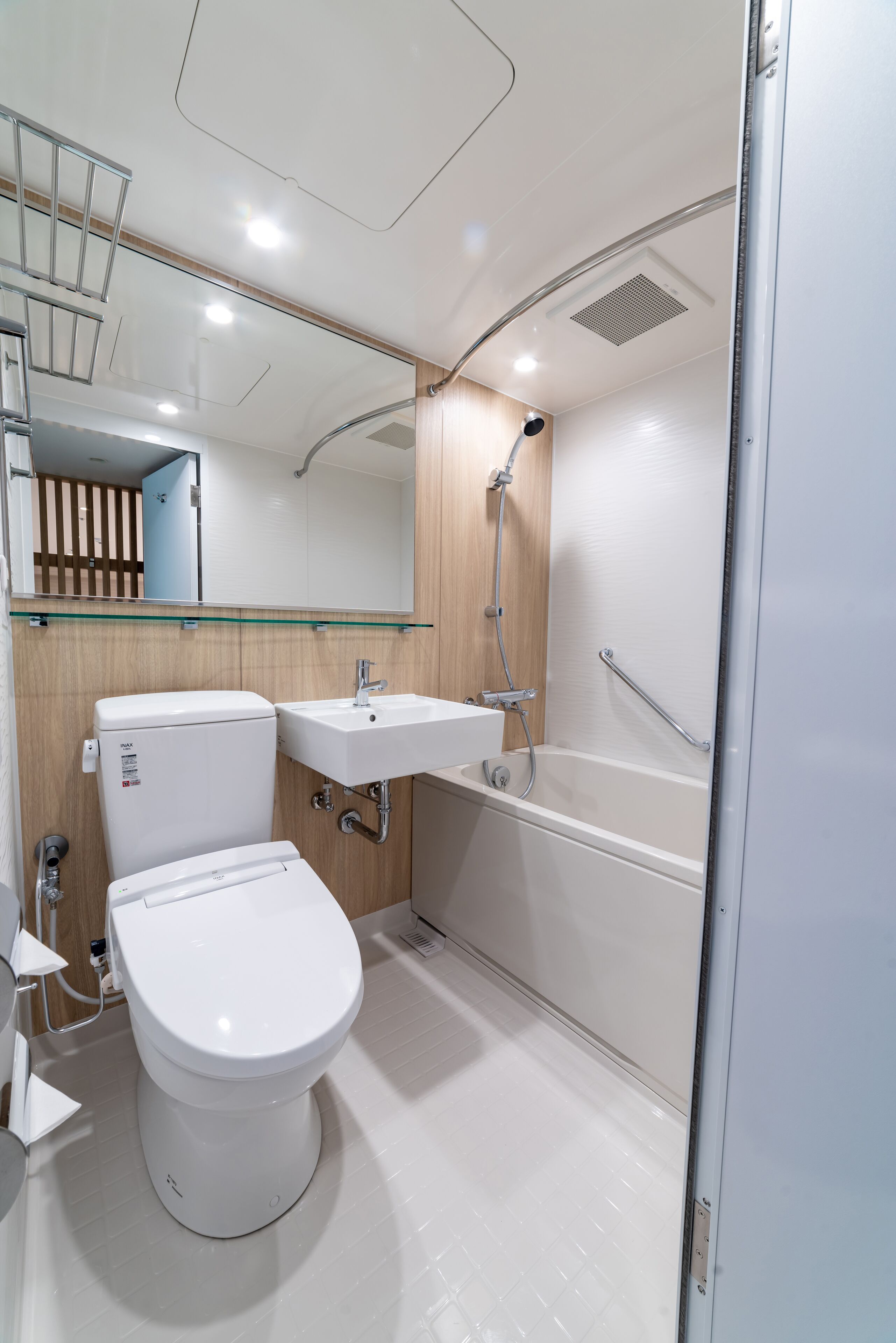 A modern bathroom with a toilet, sink, and bathtub.