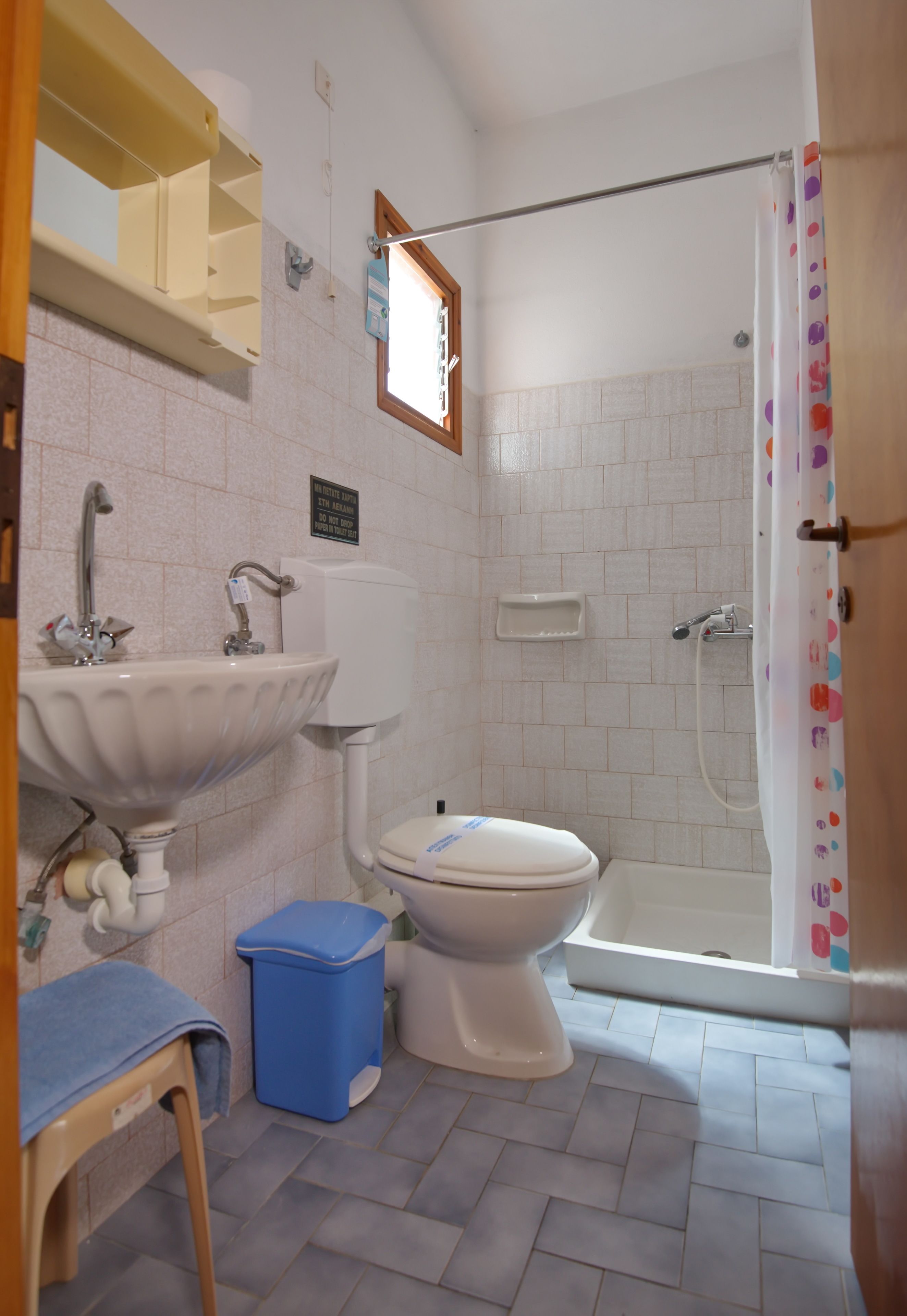 A bathroom with a sink, toilet, and shower.
