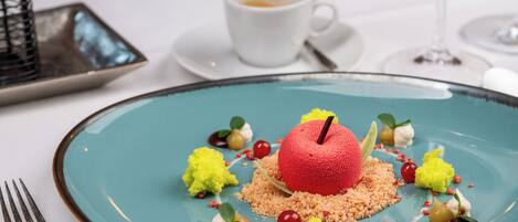A dessert on a plate with a fork beside it.