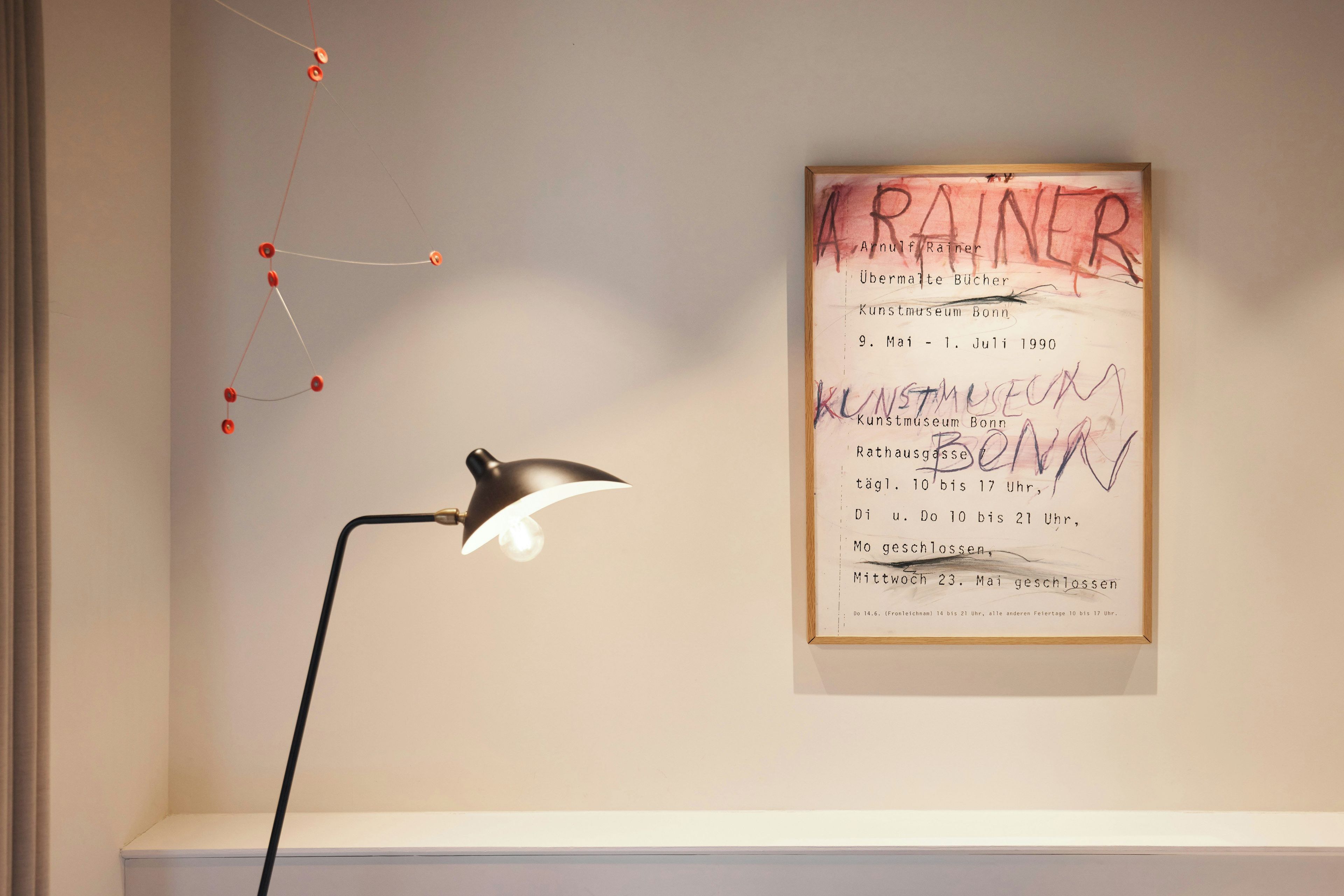 A framed artwork with text and a desk lamp.