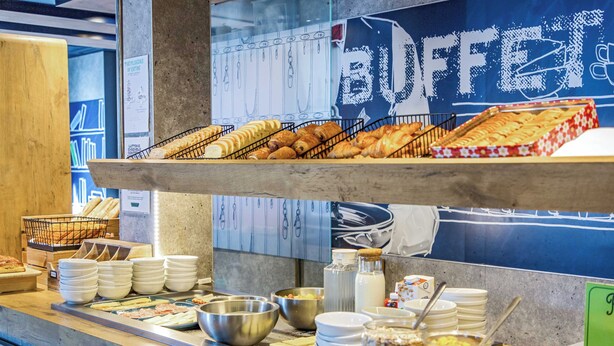 Un mostrador de buffet con diversos alimentos y utensilios.