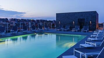 Seasonal outdoor pool, open 9:00 AM to 8:00 PM, pool loungers