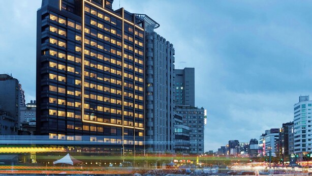 A tall, modern hotel with multiple floors and a prominent corner design. - citizenM Taipei North Gate (Taipei)