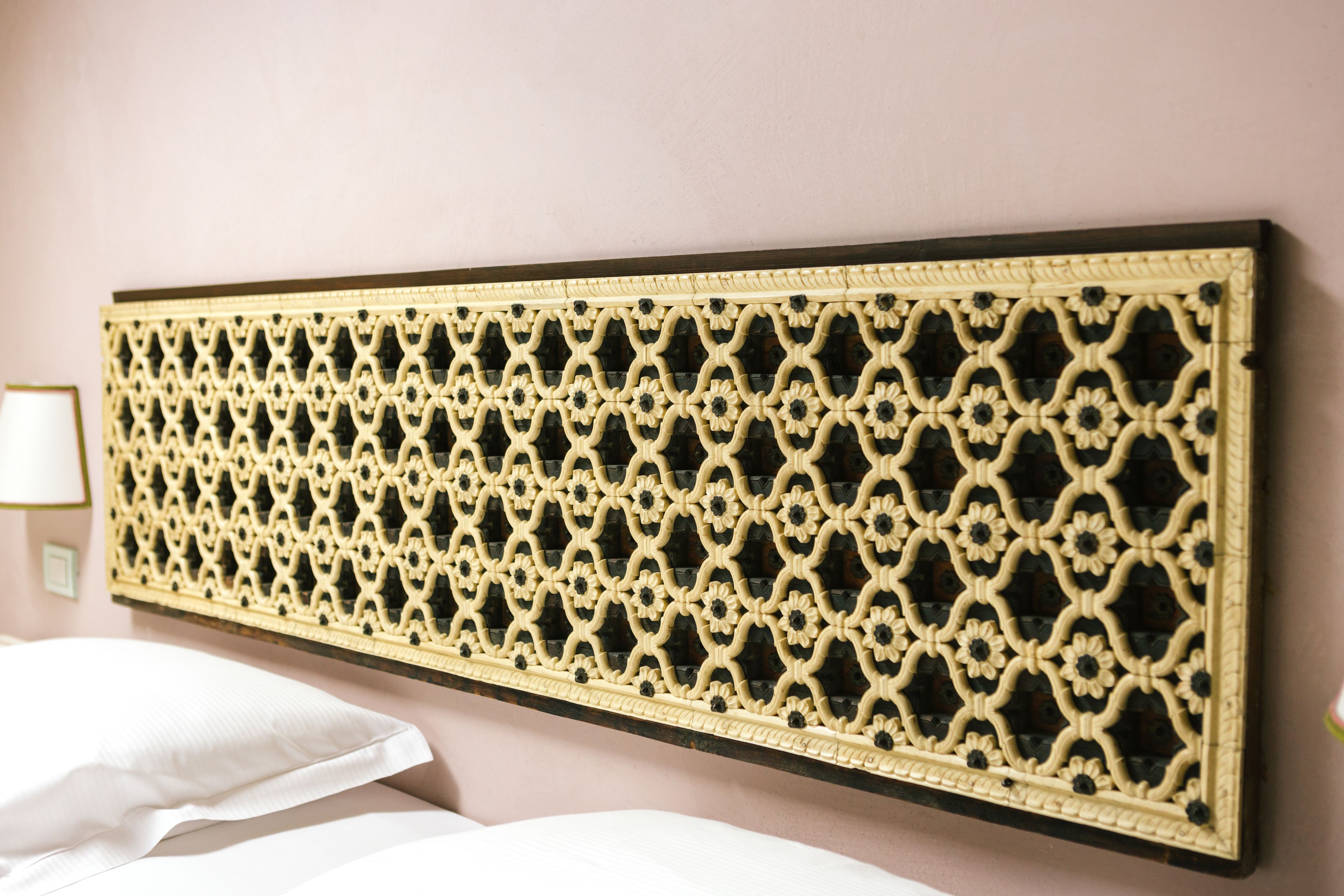 A wall-mounted decorative panel with a geometric pattern.