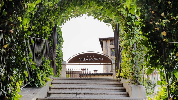 Een stenen trap die leidt naar een toegangspoort met een bord waarop 