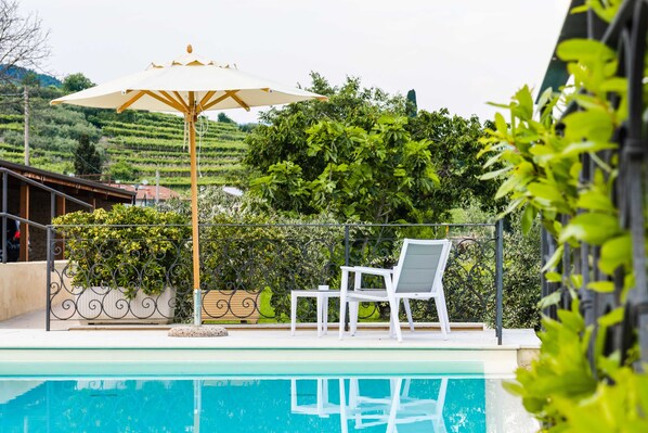Seasonal outdoor pool, open 8:00 AM to 7:30 PM, pool umbrellas