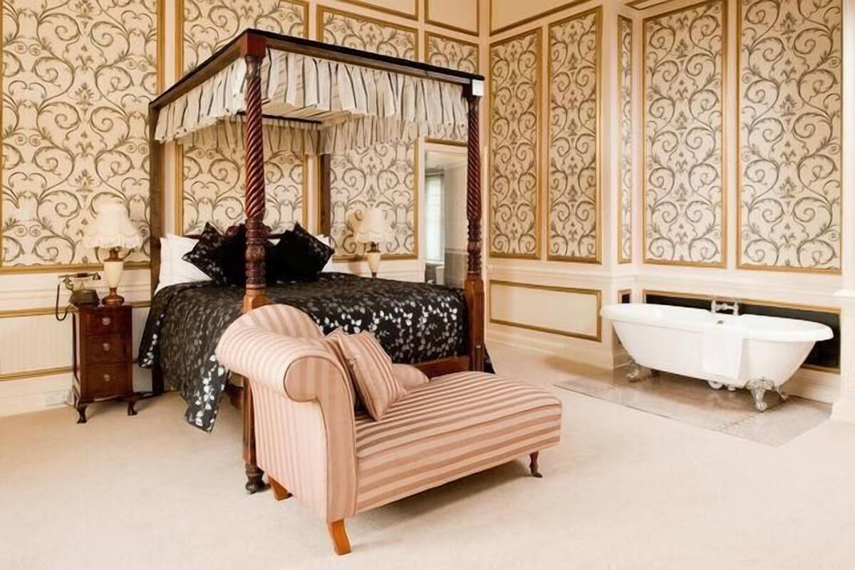 feature room | premium bedding, desk, iron/ironing board, rollaway beds