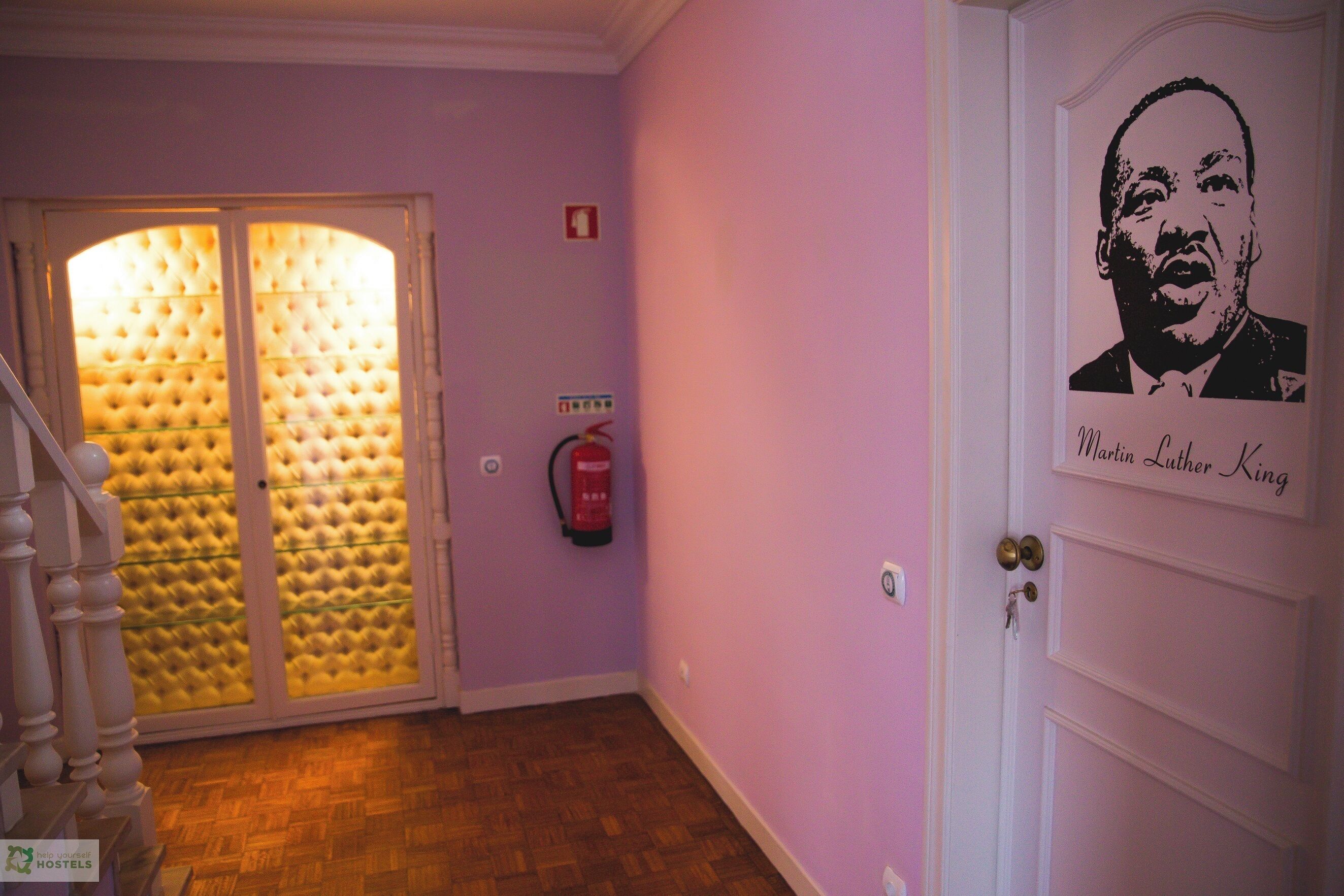 A hallway with a door labeled "Martin Luther King" and a fire extinguisher on the wall.