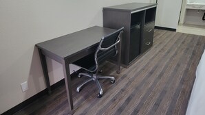 A small office space with a desk, chair, and a television mounted on the wall. - Travelodge by Wyndham Buena Park (Buena Park)