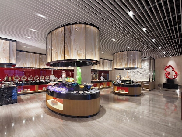A modern hotel lobby with a central buffet area, a large abstract sculpture, and a polished marble floor. - Northern Hotel Shanghai (Shanghai)