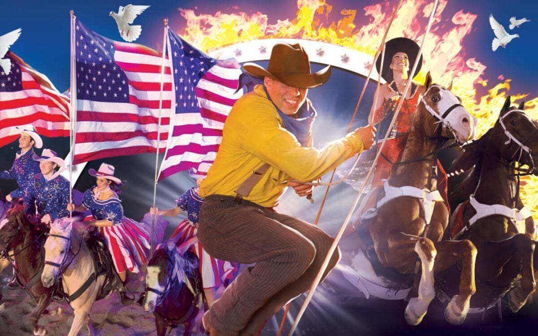 A person on horseback with a flag, surrounded by other figures and horses.