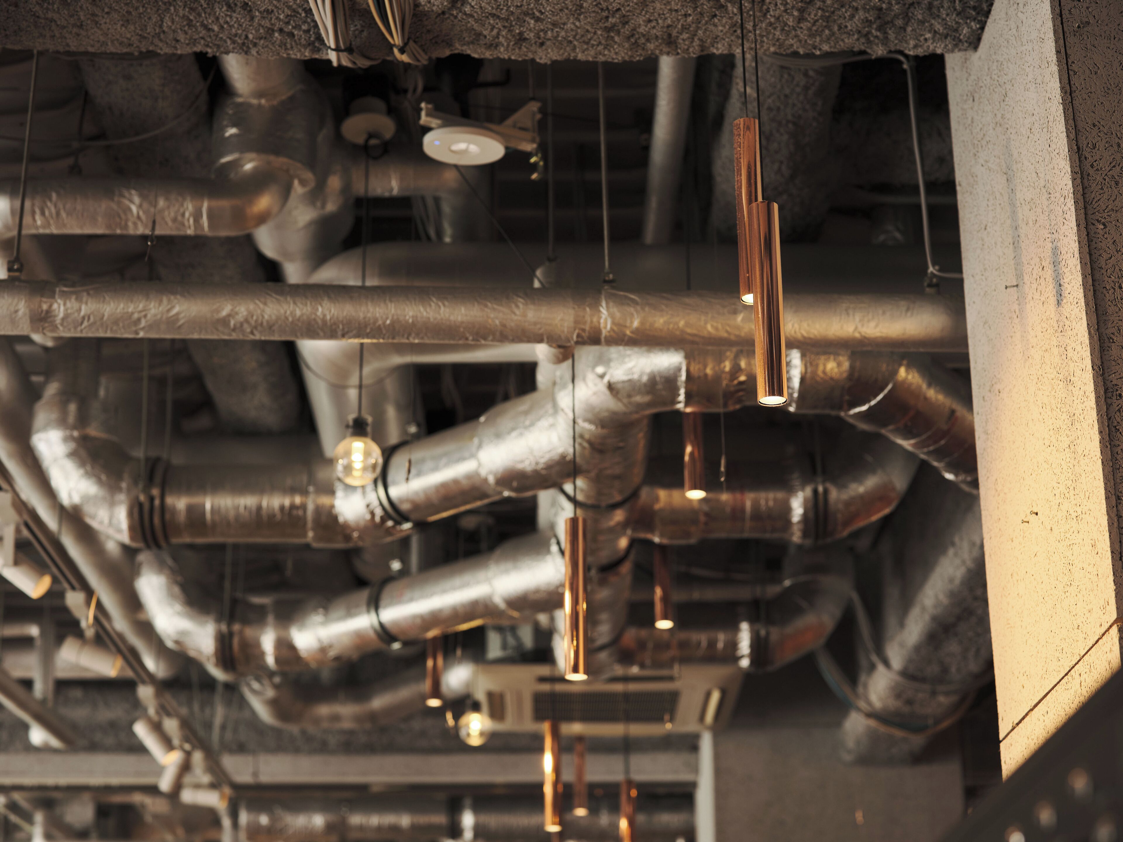 A complex network of metallic pipes and ducts, likely part of a building's HVAC system.